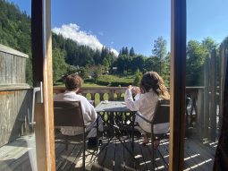 couple on a room terrace drinking their coffee at the chalet hotel & spa jeu de paume Chamonix Mont Blanc